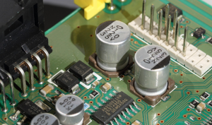 Electrolytic capacitor paper and electrolyte